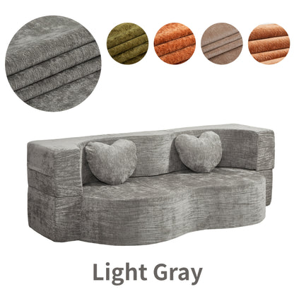 Light gray curved-front loveseat with heart pillows and color swatches
