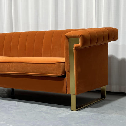 Orange Channel-Tufted Velvet Sofa — gold-tone arm frame and leg detail.