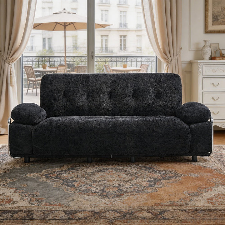 Alden black tufted sofa with steel armrests in a living room