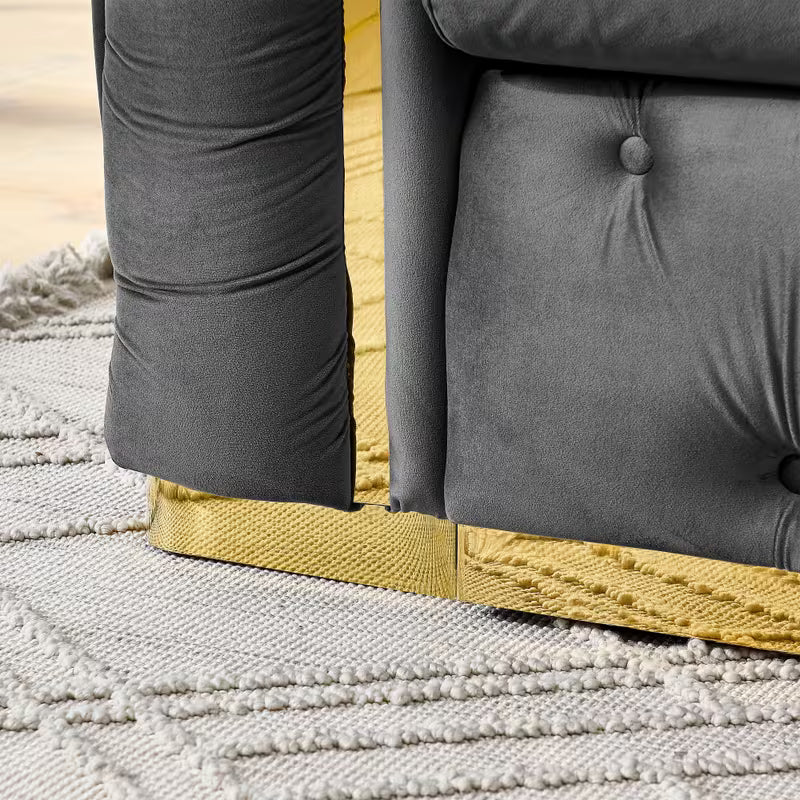 Velvet Chesterfield Sofa with Gold-Tone Trim — gold-tone base and upholstery seam detail.