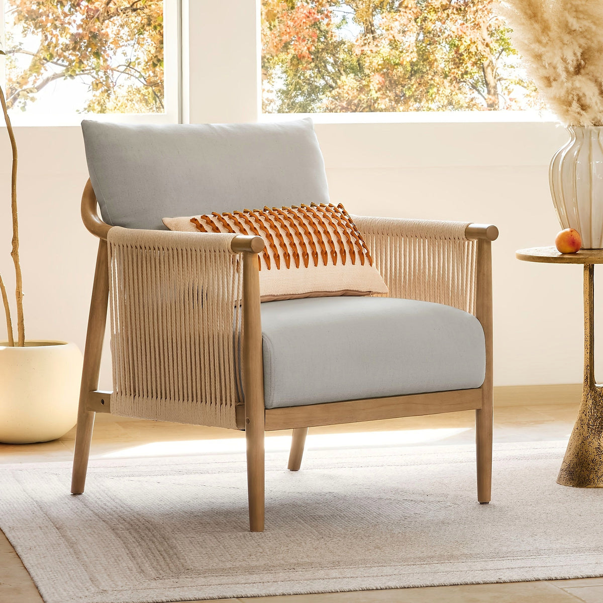 Wood frame accent chair with braided paper cord sides and a light gray cushion