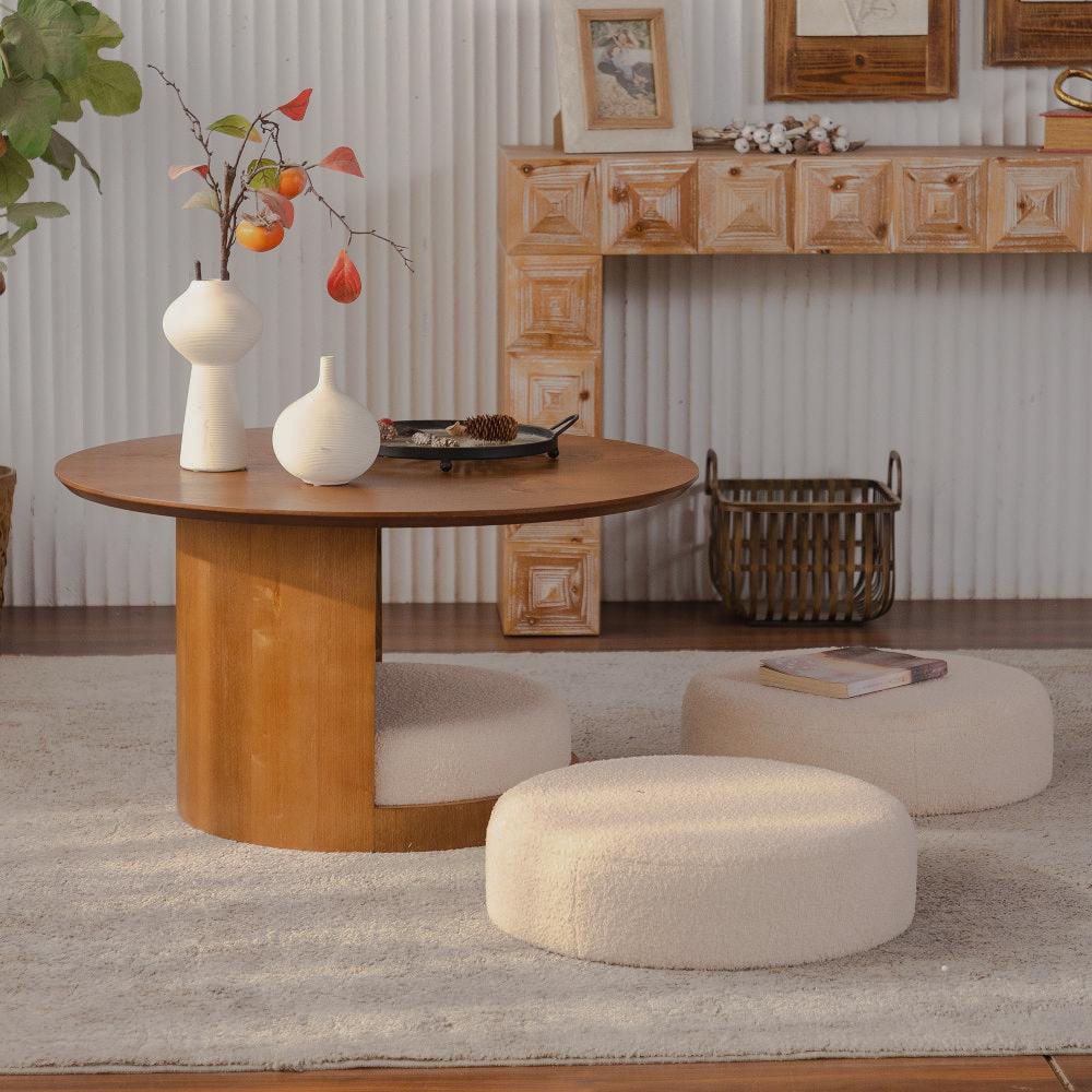 Round brown coffee table with three cream nesting stools in a living room