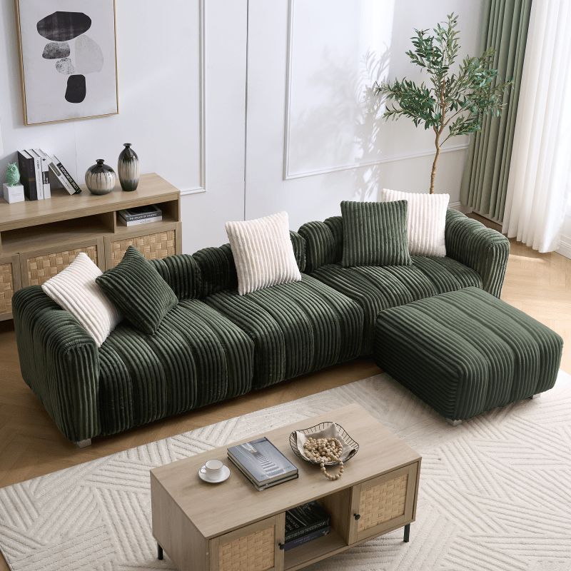 Green ribbed sectional sofa with matching footrest in a bright living room