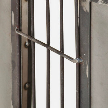 Close-up of the TV stand's gridded metal side detail beside a rounded end panel.