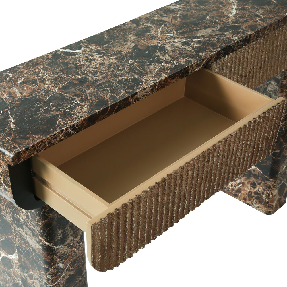 Close-up of an open drawer beneath the console’s dark marble-look top.
