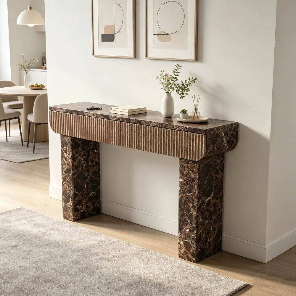 Two-drawer marble-look console styled in a bright neutral interior.