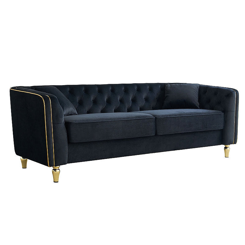 Black tufted sofa with gold-tone piping, angled front view