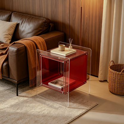 Red acrylic cube side table beside a brown sofa