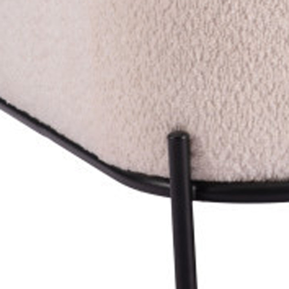 Close-up of the vanilla textured upholstery and black steel frame junction.