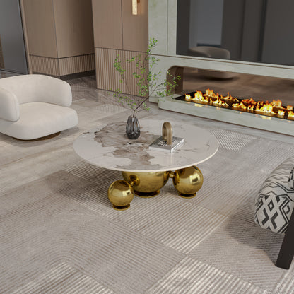 Faux-marble coffee table with reflective gold-tone ball base in a living room