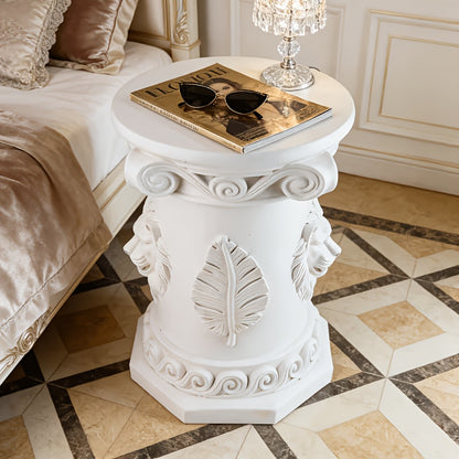 Top-down view of the round table showing leaf reliefs on the column.