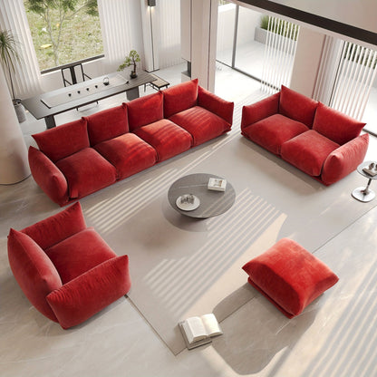 Red-orange modular seating arranged as a sofa, loveseat, chair and ottoman in a bright living room