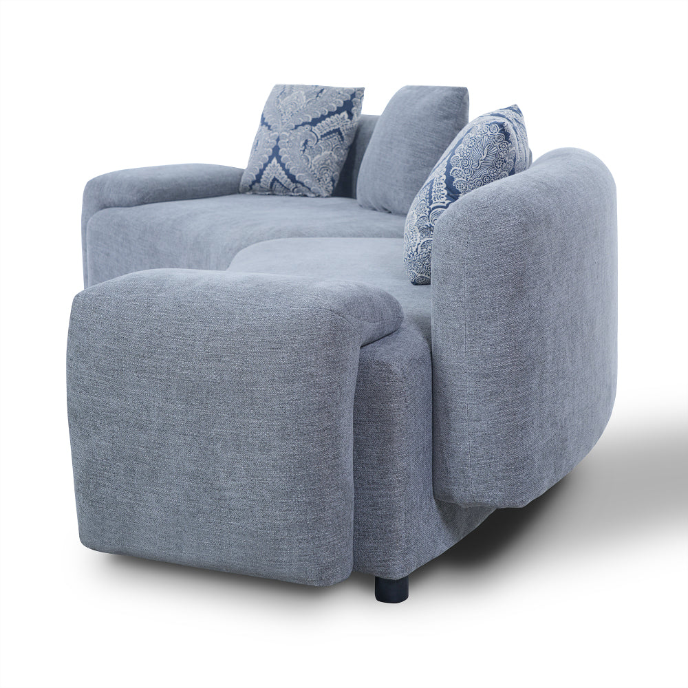 Blue-Grey Curved Sofa with Damask Pillows — side profile and rounded arm.