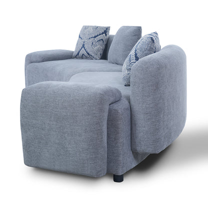 Blue-Grey Curved Sofa with Damask Pillows — side profile and rounded arm.