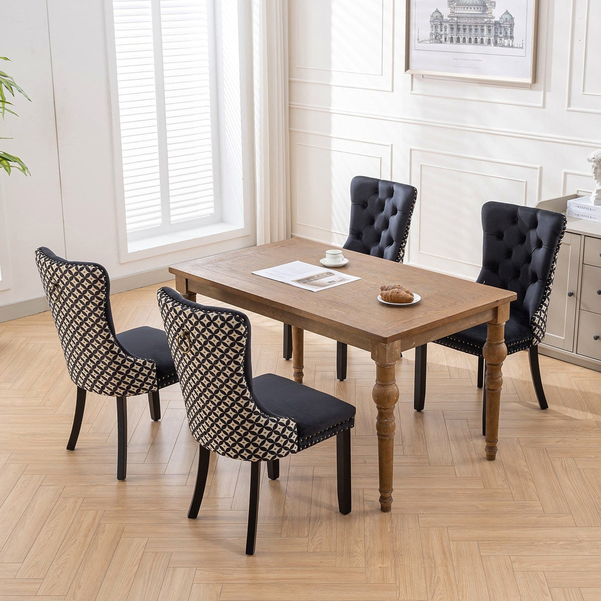 Black velvet dining chair with a patterned back and dark wood legs