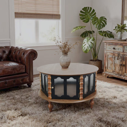 Round three-door coffee table with ribbed panels and turned legs beside a brown sofa