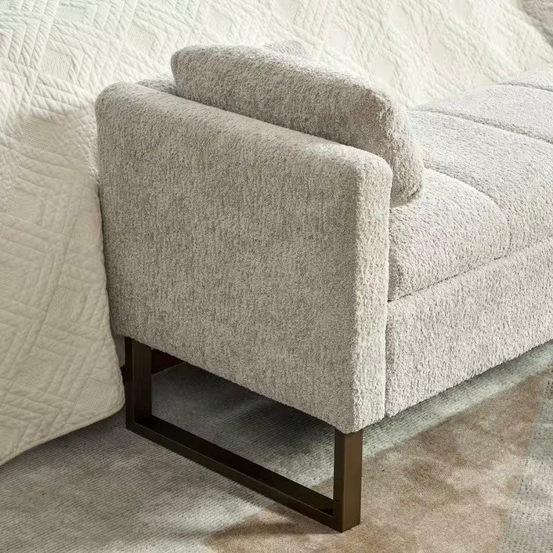 Close view of the light gray upholstered arm and dark rectangular leg frame
