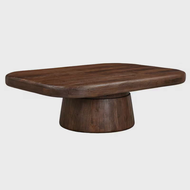 Angled studio view of the coffee table's rounded top and drum pedestal