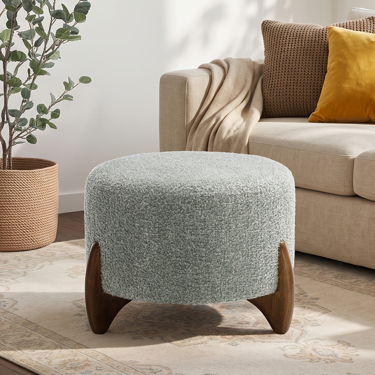 Muted green ottoman beside a sofa