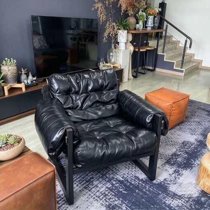Padded Sling Lounge Chair — black front three-quarter view in a living room