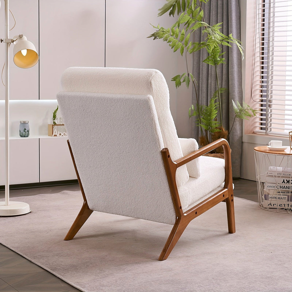 White high back upholstered lounge chair with a warm wood frame