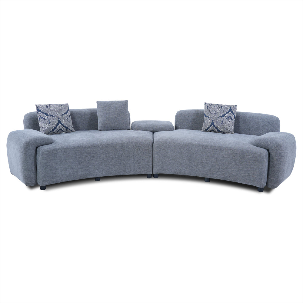 Blue-Grey Curved Sofa with Damask Pillows — front product view on white.