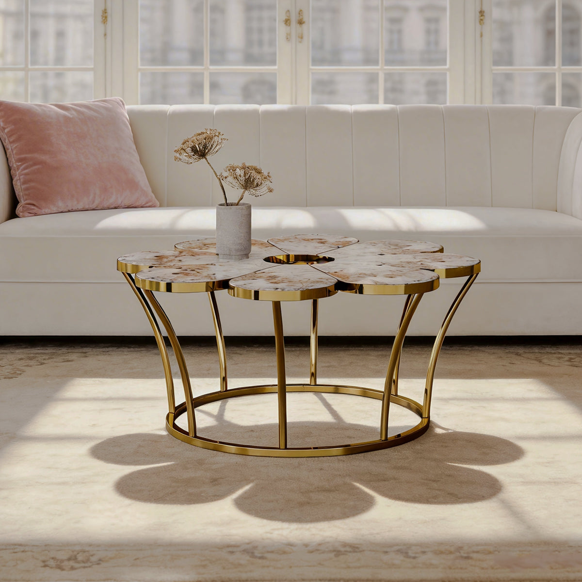 Flower-shaped coffee table with a gold-tone frame beside a white sofa