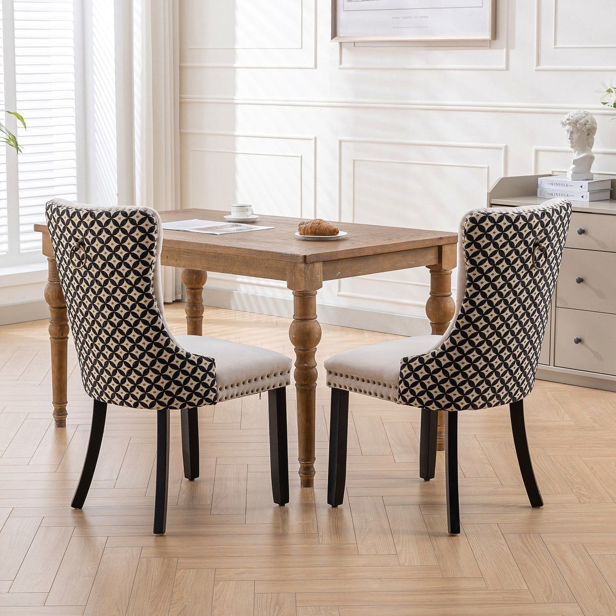 Beige velvet dining chair with a patterned back and dark wood legs