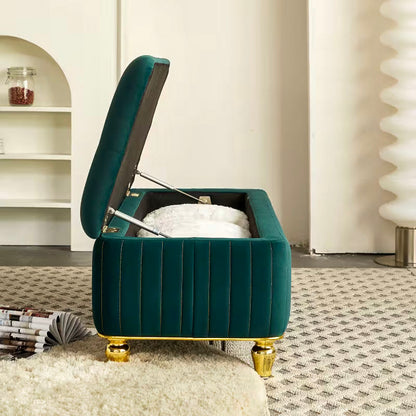 End view of the green bench with its lid raised above the lined storage compartment