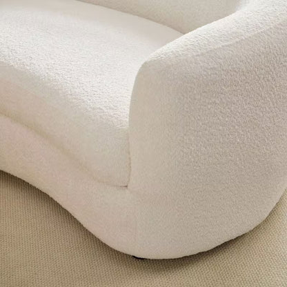 Ivory Curved Sofa with Four Pillows — seat and rounded arm seam detail.