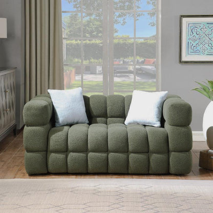 Olive green block-tufted sofa with white pillows in a bright room