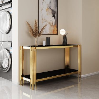Black glass and gold console styled below wall art.