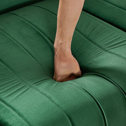 Close-up of the emerald green velvet seat cushion under hand pressure