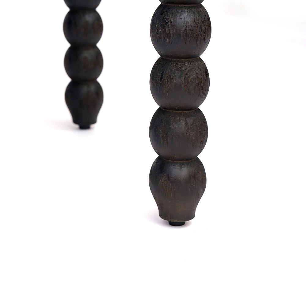 Black turned spindle-leg detail beneath the storage bench