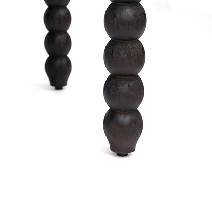 Black turned spindle-leg detail beneath the storage bench