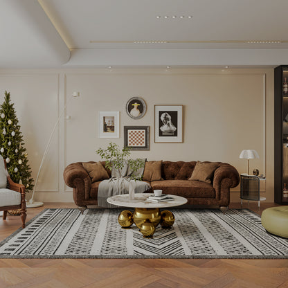 Gold-tone ball-base coffee table in a wide living-room scene