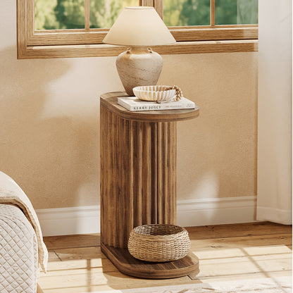Fluted oval side table styled with a lamp against a wall.