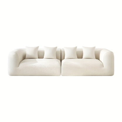 Front view of the two sofa sections with rounded arms and four pillows against a white background.