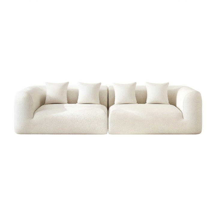 Front view of the two sofa sections with rounded arms and four pillows against a white background.