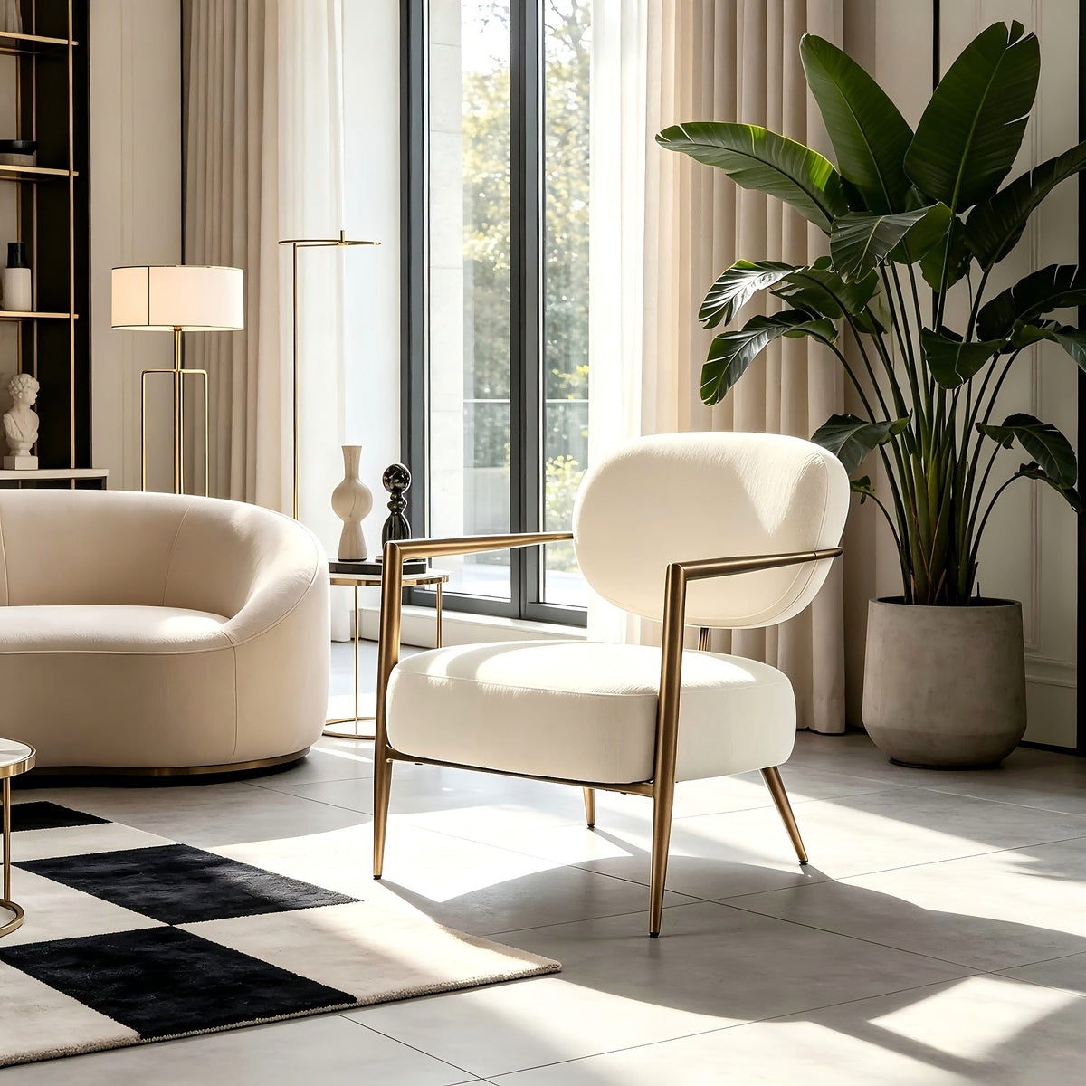 White fabric accent chair with an oval back and gold tone metal frame