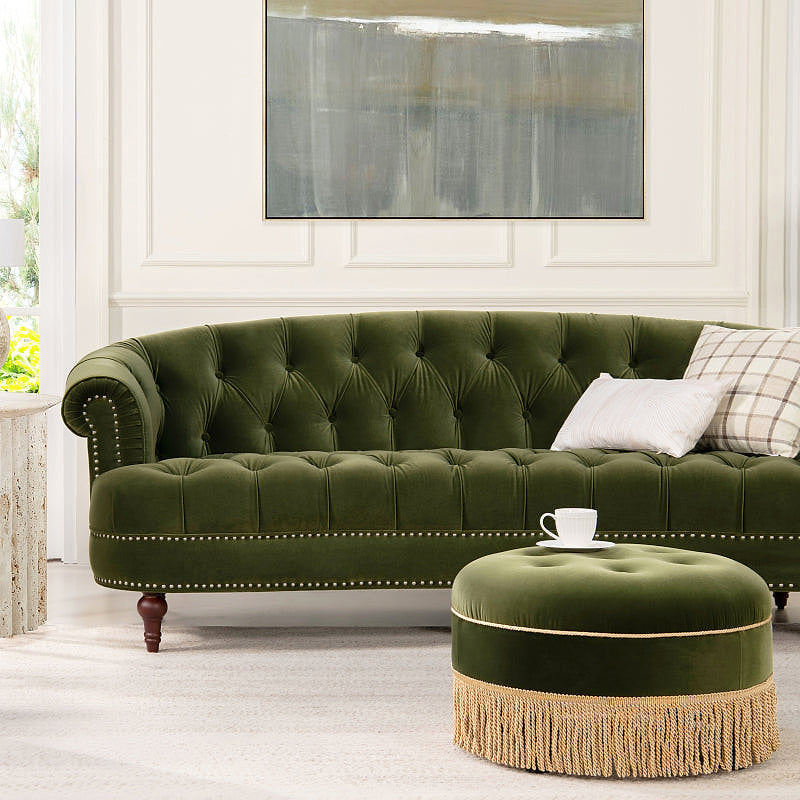 La Rosa Olive Green Velvet Chesterfield Sofa — styled with an ottoman shown as a room accessory