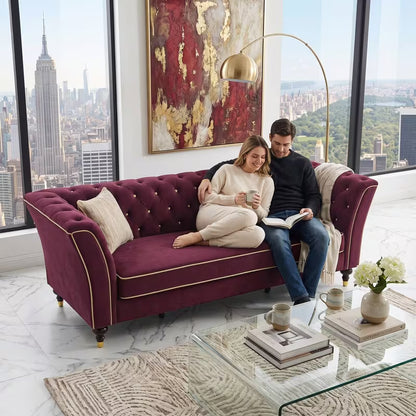 Chesterfield Sofa with Contrast Piping — burgundy sofa shown with two people seated.