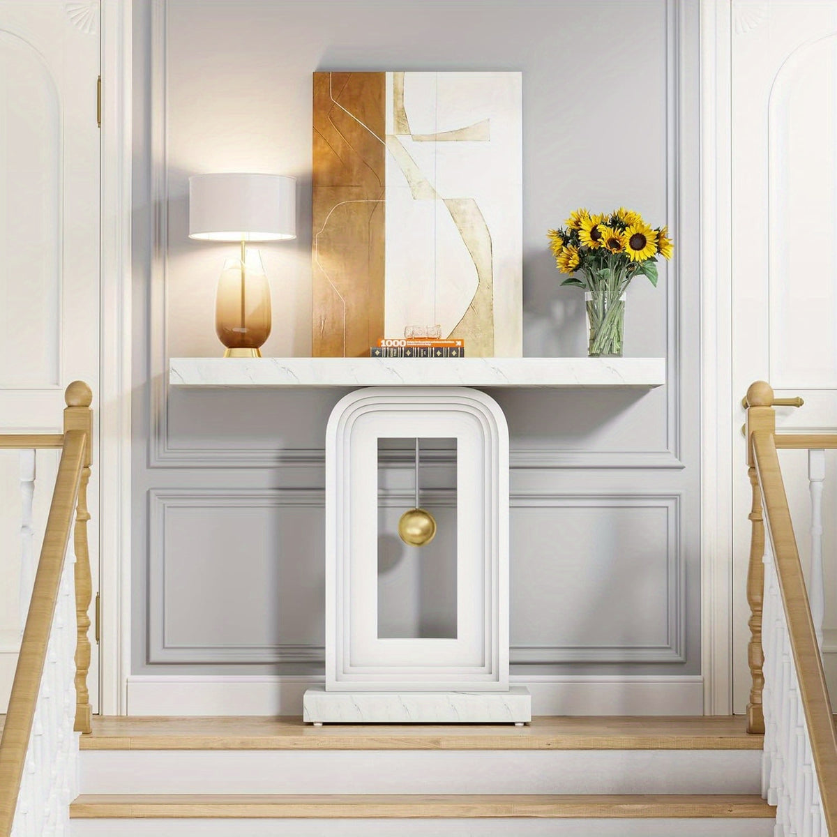 White pendulum console styled with a lamp and sunflowers on a bright stair landing