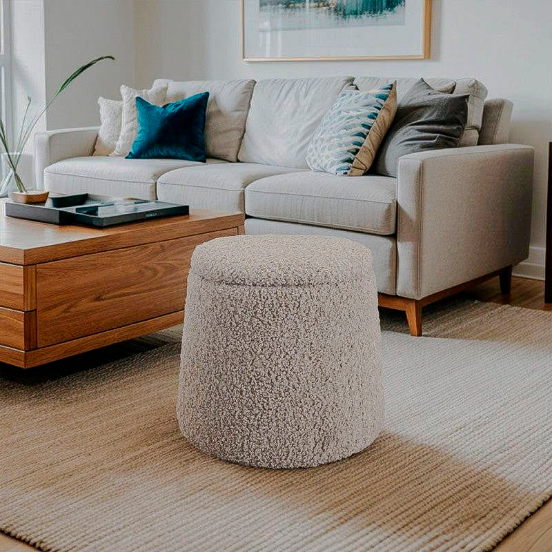 Greige cylindrical boucle storage ottoman beside sofa