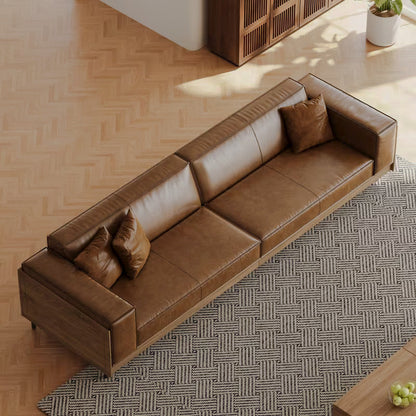 Overhead angled view of the brown sofa's seat cushions and wood frame