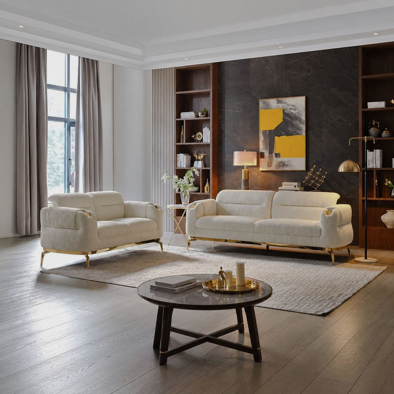 Cream Zoe sofa and loveseat with gold legs in a living room
