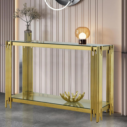 Clear glass and gold frame console styled with a lamp in a modern interior.