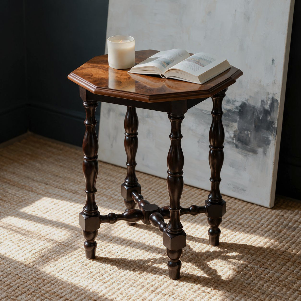 Octagonal Burl Wood Side Table — main room view with candle and open book