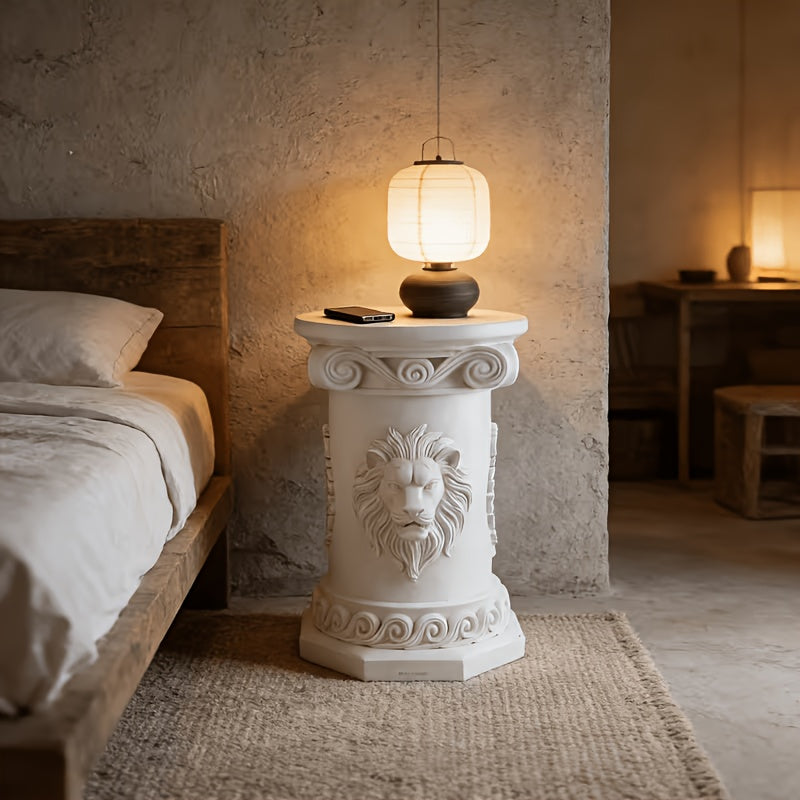 Lion-relief side table used as a bedside display surface.