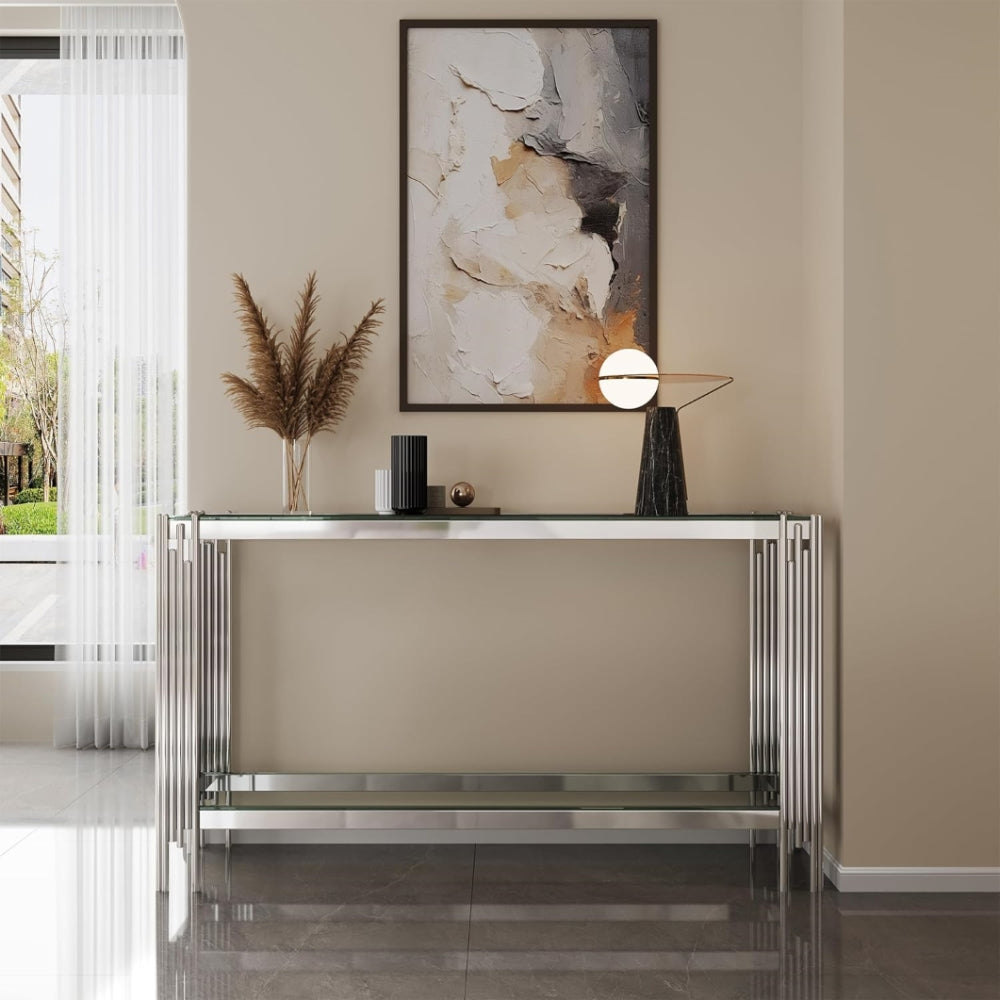 Front room view of the clear glass console with silver split-column legs.
